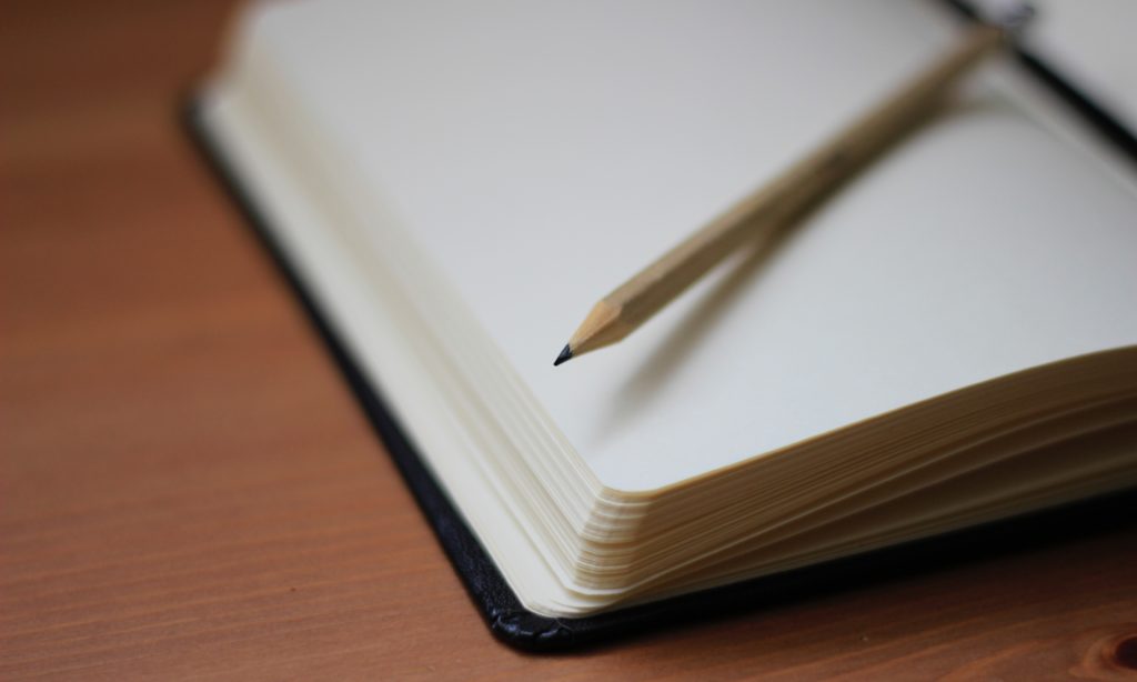 Closeup photo of a pencil and notepad