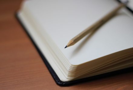 Closeup photo of a pencil and notepad