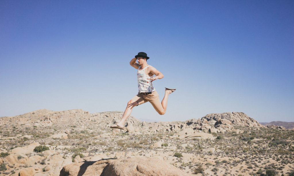 Photo of an exuberant man jumping in the desert