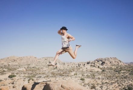 Photo of an exuberant man jumping in the desert