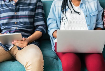 Photo of two nursing students using a laptop and a tablet