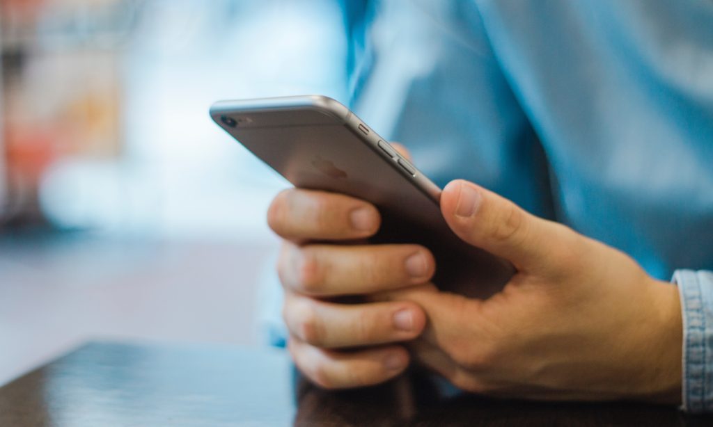 Closeup photo of a nurse practitioner using a smartphone