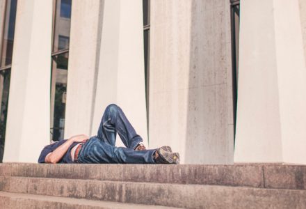 Photo of an exhausted nurse practitioner lying on the ground