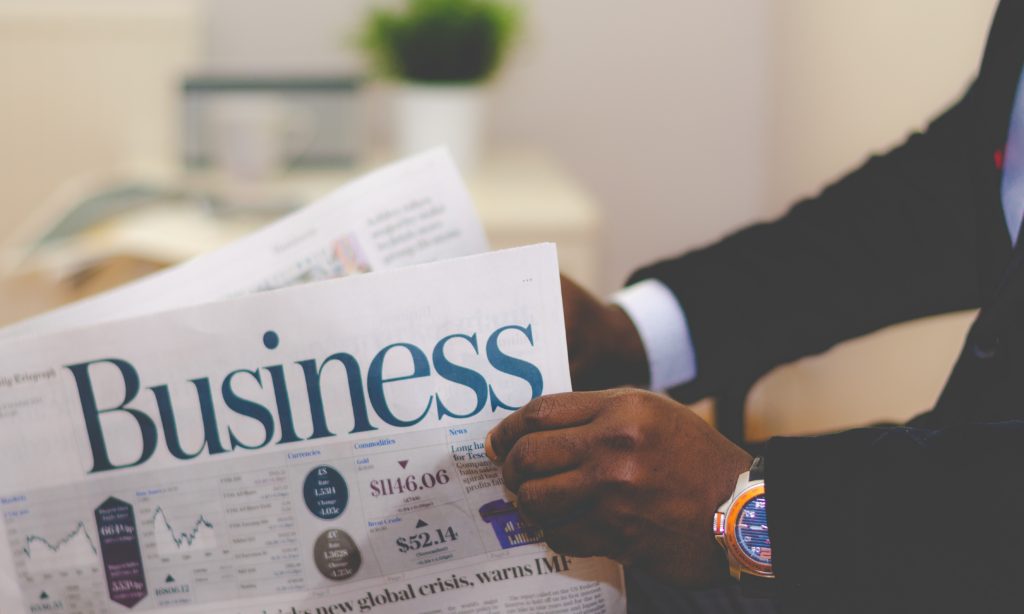 Photo of a buisnessman reading a newspaper