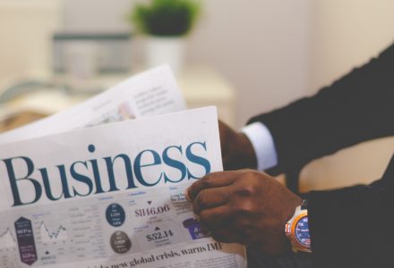 Photo of a buisnessman reading a newspaper