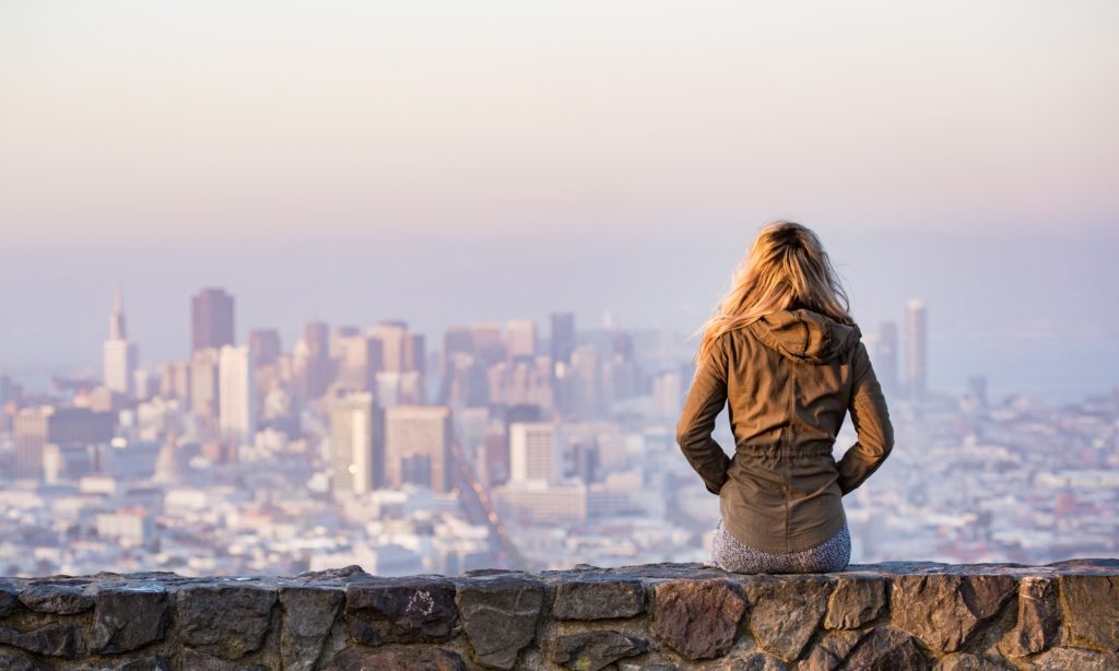 Photo of a nurse practitioner looking at a city skyline