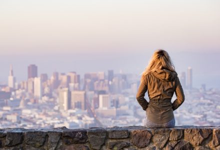 Photo of a nurse practitioner looking at a city skyline