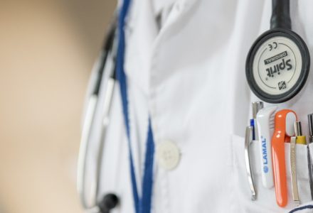 A closeup photo of a nurse practitioner wearing a lab coat