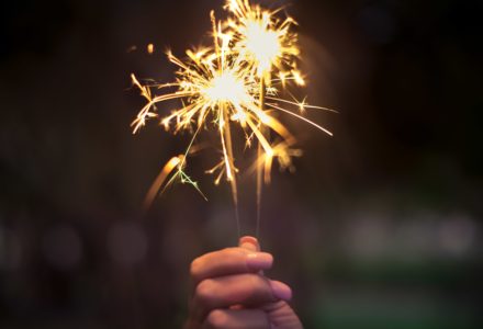 Closeup photo of a nurse practitioner holding a sparkler firework