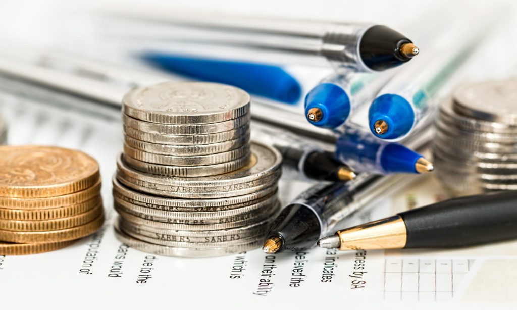 Closeup photo of coins and pens