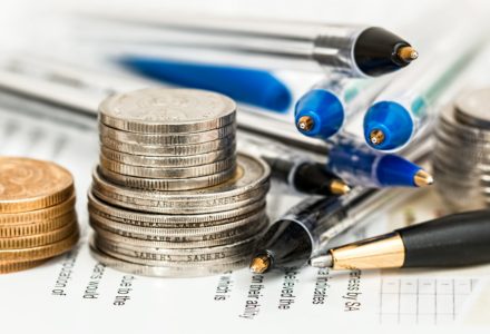 Closeup photo of coins and pens