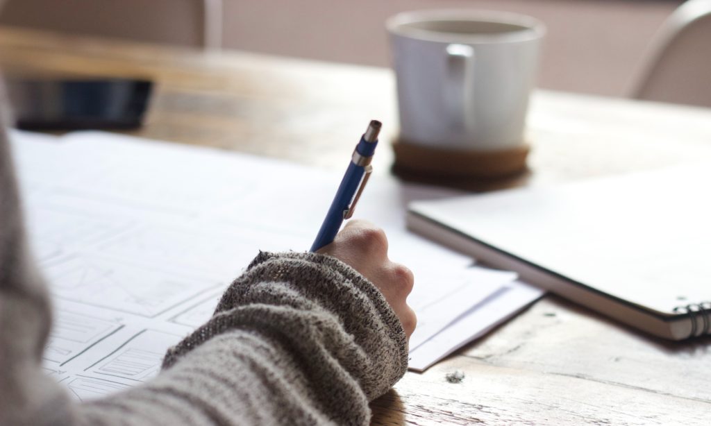 Photo of a nurse practitioner taking notes with a pen