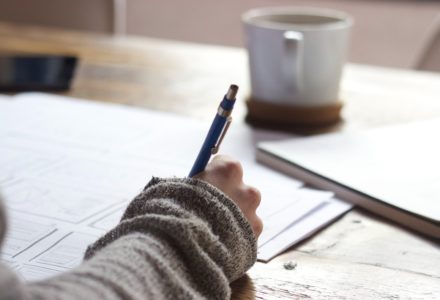 Photo of a nurse practitioner taking notes with a pen