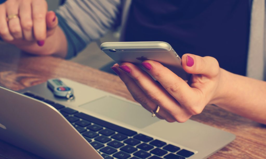 Photo of a nurse practitioner working in telehealth on her phone