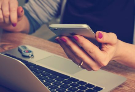 Photo of a nurse practitioner working in telehealth on her phone